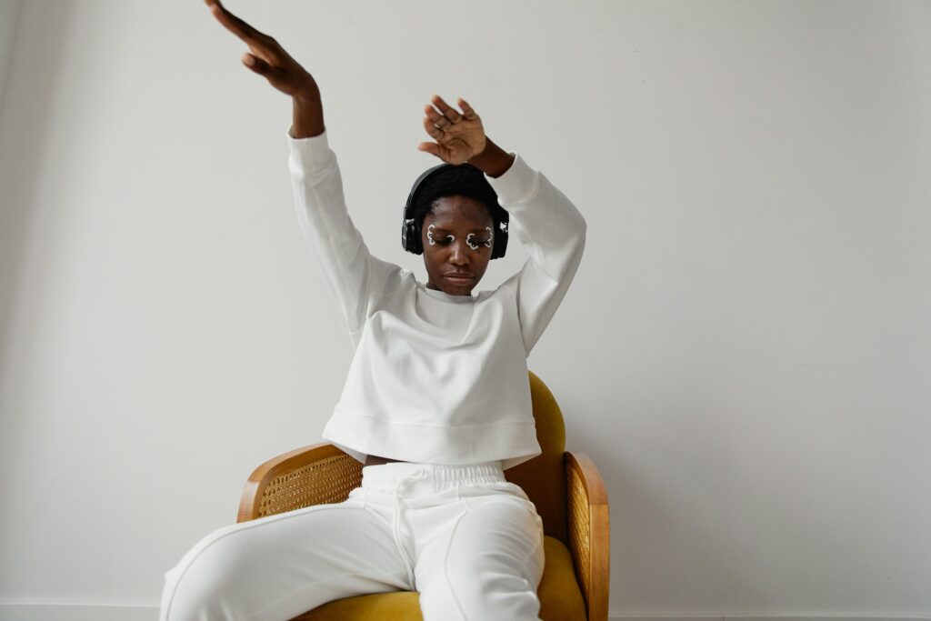 A Woman Dancing on Her Seat Listening to Music